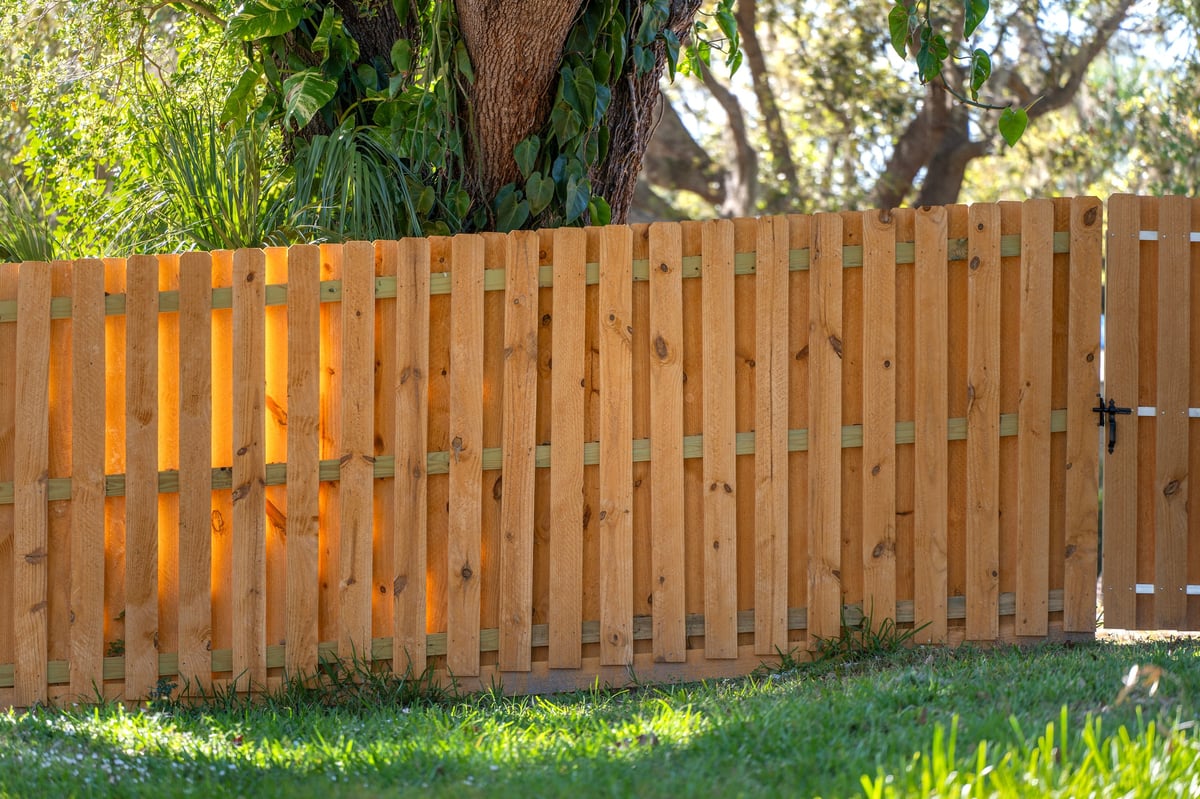 Wooden plank fence in Florida backyard providing timber fencing for privacy
